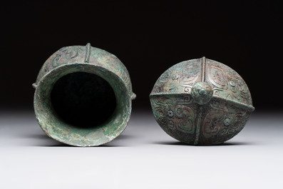 A Chinese archaic bronze food vessel and cover with taotie design, 'zhi 觶', Shang