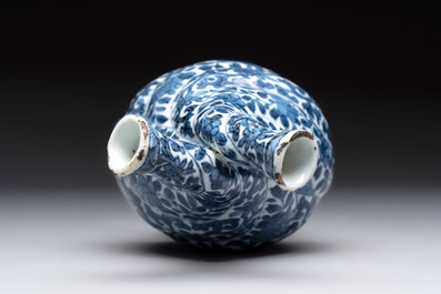 A Chinese blue and white double-spouted swirling-lobed cruet, Kangxi