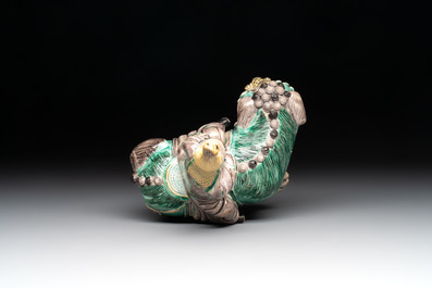 A Chinese verte biscuit 'Sogdian riding a Buddhist lion' group, 19th C.