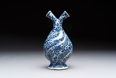 A Chinese blue and white double-spouted swirling-lobed cruet, Kangxi