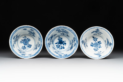 12 Chinese blue and white cups and 11 saucers with birds among flowering branches, Kangxi