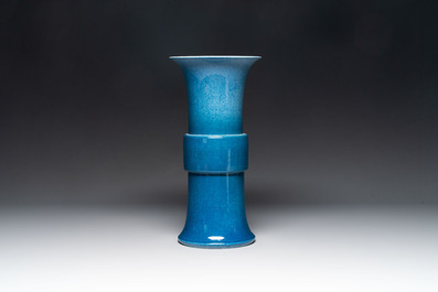 A Chinese black-glazed bottle vase, a blue-glazed jar and a powder-blue 'gu' vase on a wooden stand, Qianlong mark, 19/20th C.