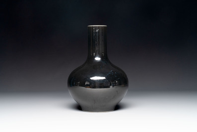 A Chinese black-glazed bottle vase, a blue-glazed jar and a powder-blue 'gu' vase on a wooden stand, Qianlong mark, 19/20th C.