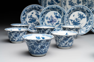 12 Chinese blue and white cups and 11 saucers with birds among flowering branches, Kangxi