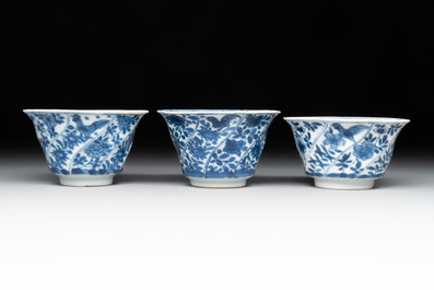12 Chinese blue and white cups and 11 saucers with birds among flowering branches, Kangxi