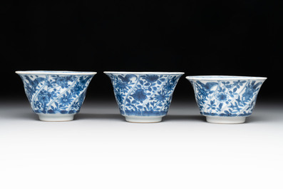 12 Chinese blue and white cups and 11 saucers with birds among flowering branches, Kangxi