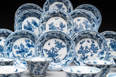 12 Chinese blue and white cups and 11 saucers with birds among flowering branches, Kangxi