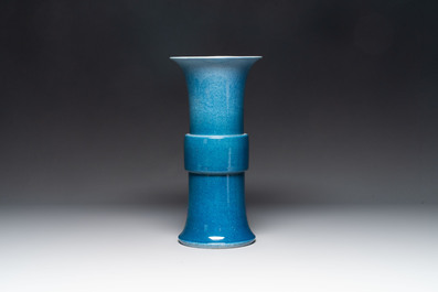 A Chinese black-glazed bottle vase, a blue-glazed jar and a powder-blue 'gu' vase on a wooden stand, Qianlong mark, 19/20th C.