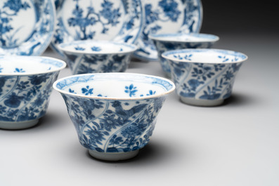 12 Chinese blue and white cups and 11 saucers with birds among flowering branches, Kangxi