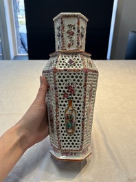 A pair of Chinese famille rose reticulated double-walled 'mandarin subject' vases, Qianlong