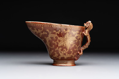A Chinese gilt-decorated brown-glazed libation cup with a chilong-form handle, Qianlong mark and of the period