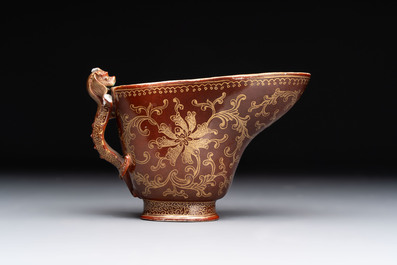 A Chinese gilt-decorated brown-glazed libation cup with a chilong-form handle, Qianlong mark and of the period