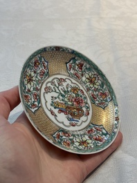 A fine Chinese gilt-decorated famille rose 'flower basket' cup and saucer, Yongzheng