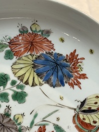 A Chinese gilt-decorated powder-blue plate and a famille verte plate with flowers, Kangxi/Qianlong