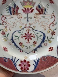 A pair of Chinese famille rose 'winged putti' plates, Yongzheng/Qianlong