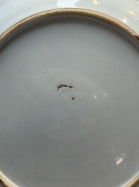 A pair of Chinese famille rose 'winged putti' plates, Yongzheng/Qianlong