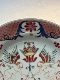 A pair of Chinese famille rose 'winged putti' plates, Yongzheng/Qianlong