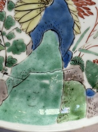 A Chinese gilt-decorated powder-blue plate and a famille verte plate with flowers, Kangxi/Qianlong