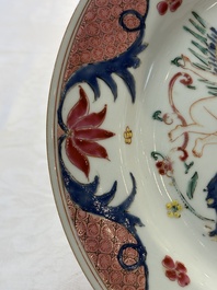 A pair of Chinese famille rose 'winged putti' plates, Yongzheng/Qianlong