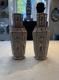A pair of Chinese famille rose reticulated double-walled 'mandarin subject' vases, Qianlong