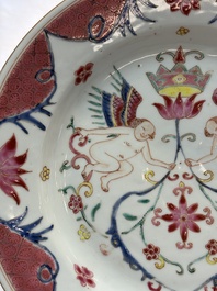 A pair of Chinese famille rose 'winged putti' plates, Yongzheng/Qianlong