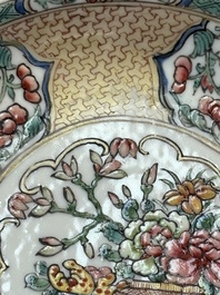 A fine Chinese gilt-decorated famille rose 'flower basket' cup and saucer, Yongzheng