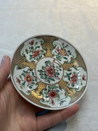 A fine Chinese gilt-decorated famille rose cup and saucer with floral design, Yongzheng