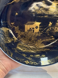 A Chinese gilt-decorated powder-blue plate and a famille verte plate with flowers, Kangxi/Qianlong