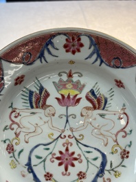 A pair of Chinese famille rose 'winged putti' plates, Yongzheng/Qianlong