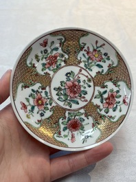 A fine Chinese gilt-decorated famille rose cup and saucer with floral design, Yongzheng