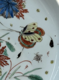 A Chinese gilt-decorated powder-blue plate and a famille verte plate with flowers, Kangxi/Qianlong
