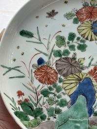 A Chinese gilt-decorated powder-blue plate and a famille verte plate with flowers, Kangxi/Qianlong
