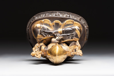 A Tibetan parcel-gilt bronze sculpture of a lama, 20th C.