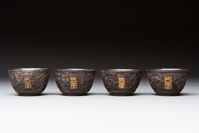 Four Chinese carved and silver-lined coconut cups, 19/20th C.