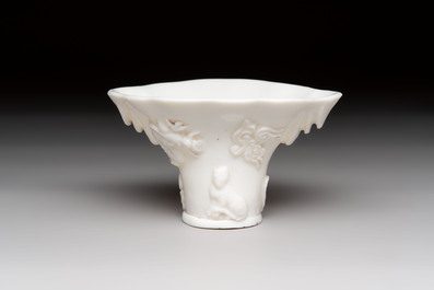 A Chinese Dehua blanc de Chine libation cup, a famille rose cup and two figures, 19th C.