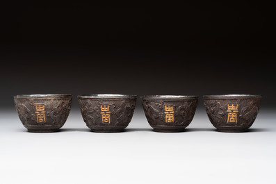 Four Chinese carved and silver-lined coconut cups, 19/20th C.