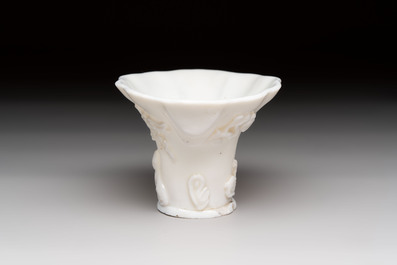 A Chinese Dehua blanc de Chine libation cup, a famille rose cup and two figures, 19th C.