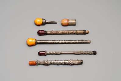 Four Ottoman silver niello cigarette holders with amber and cherry amber, and two hookah mouthpieces for the Islamic market, 19th C.