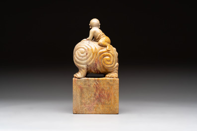 A Chinese soapstone carving of a boy riding an elephant, 20th C.