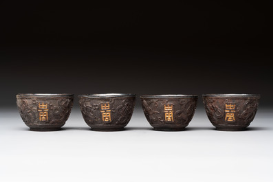 Four Chinese carved and silver-lined coconut cups, 19/20th C.