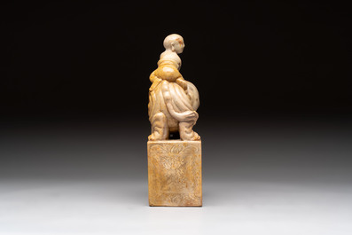 A Chinese soapstone carving of a boy riding an elephant, 20th C.