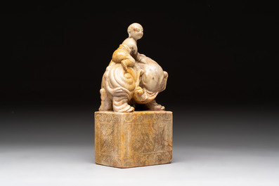 A Chinese soapstone carving of a boy riding an elephant, 20th C.