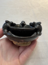 A rare Chinese black-glazed two-tier oil lamp with three rats, Ming