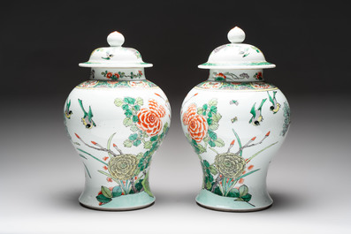 A pair of Chinese famille verte 'birds and flowers' vases and covers, 19th C.