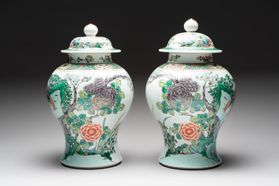A pair of Chinese famille verte 'birds and flowers' vases and covers, 19th C.