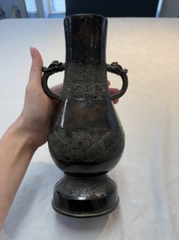 A fine Chinese archaistic bronze 'hu' vase with dragon handles, Yuan