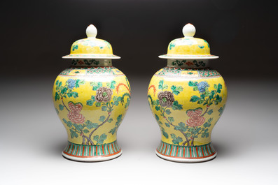 A pair of Chinese famille verte yellow-ground 'pheasants and peonies' vases and covers, 19th C.