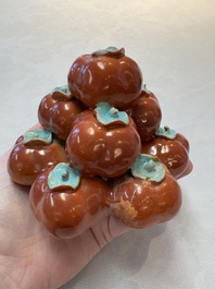 A pair of Chinese polychrome 'persimmons' groups on wooden stands, 19th C.