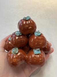 A pair of Chinese polychrome 'persimmons' groups on wooden stands, 19th C.