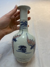A pair of Chinese blue, white and copper-red 'bats among the clouds' vases, 19th C.